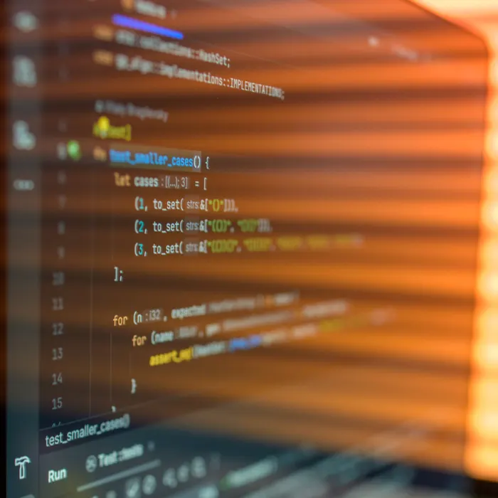 Code on a computer screen in warm light